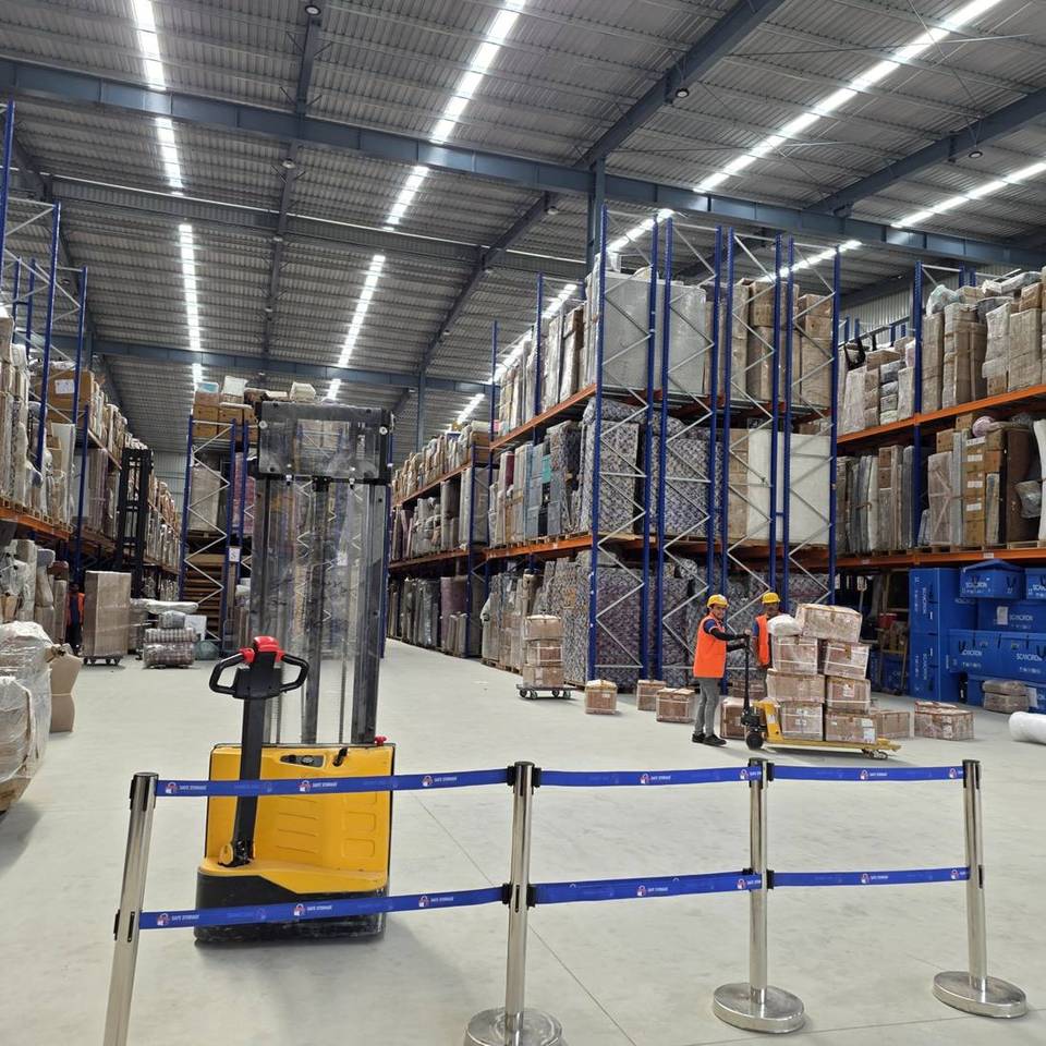 Inside a SafeStorage warehouse: barcoded household goods on racked pallets